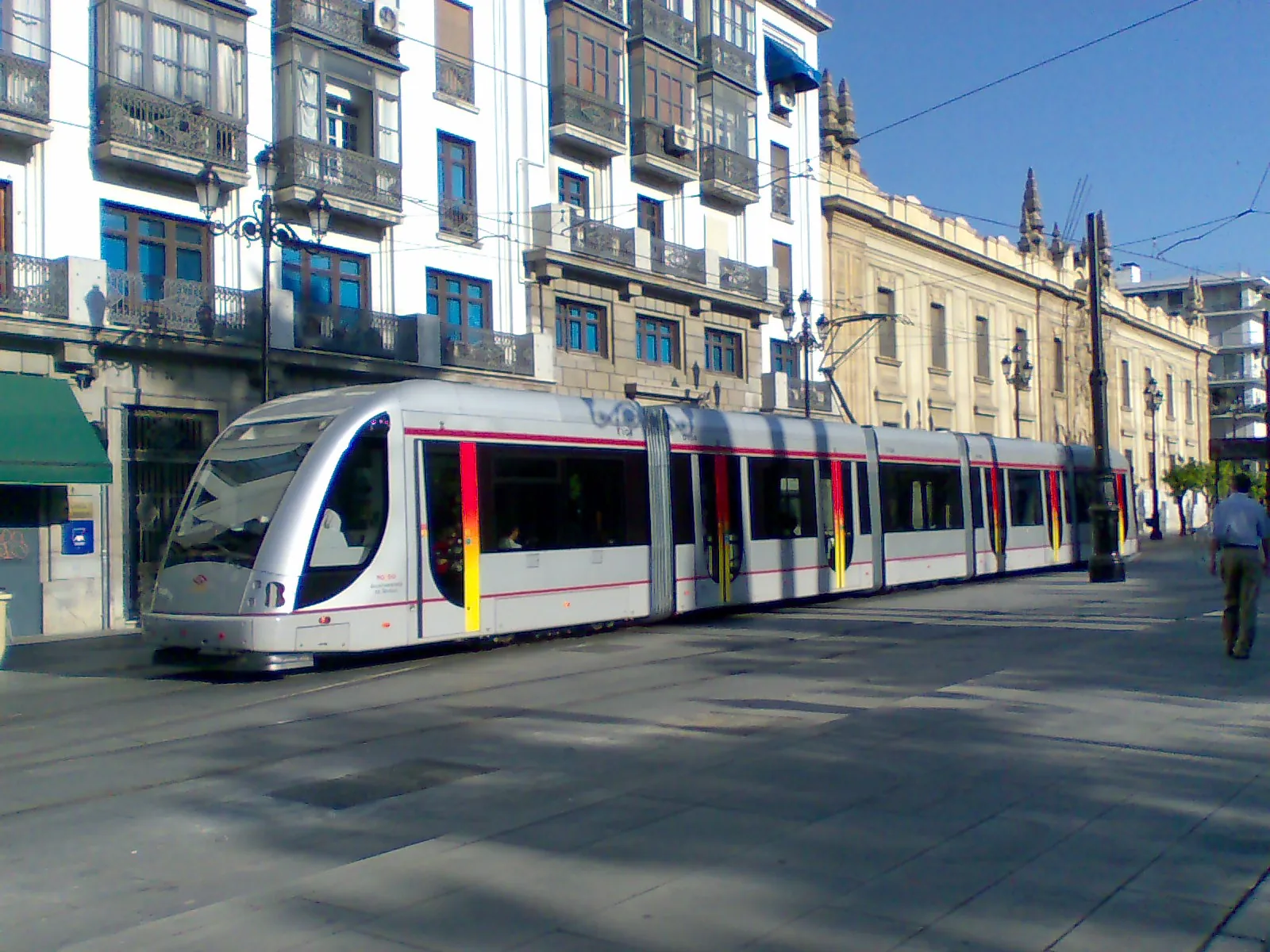 Seville's tram gliding along Avenida de la Constitución