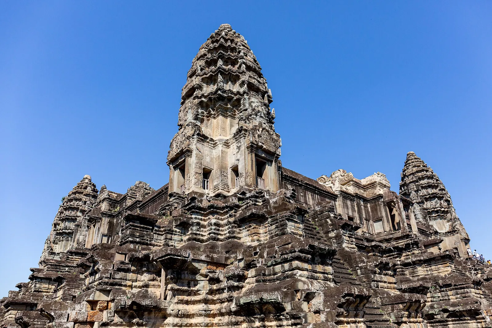 Angkor Wat's carved towers under a clear blue sky