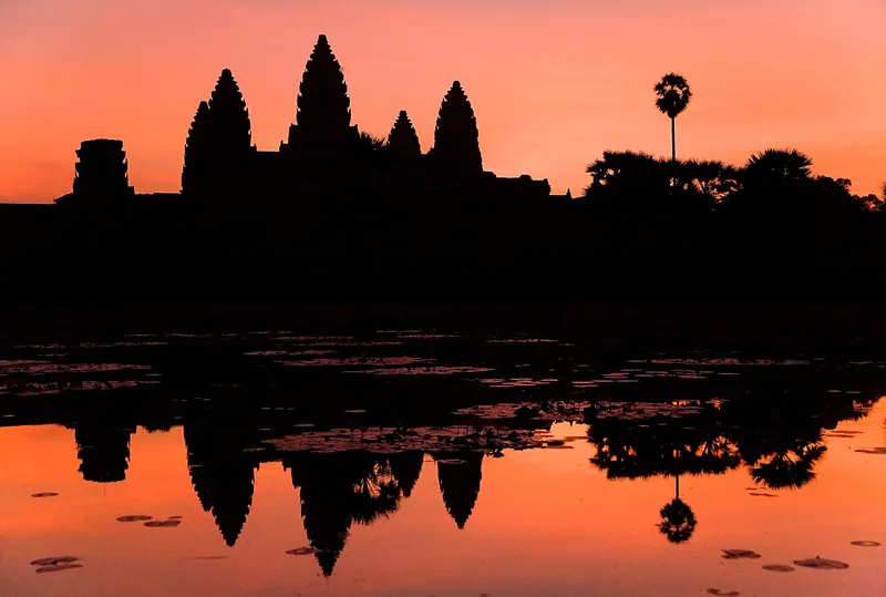 Angkor Wat's towers reflected in the pond at sunrise