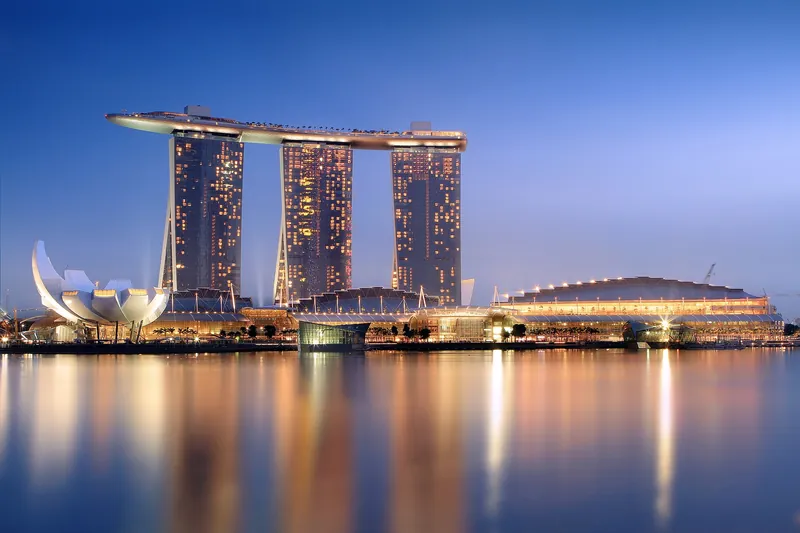Marina Bay Sands glowing over the bay at dusk