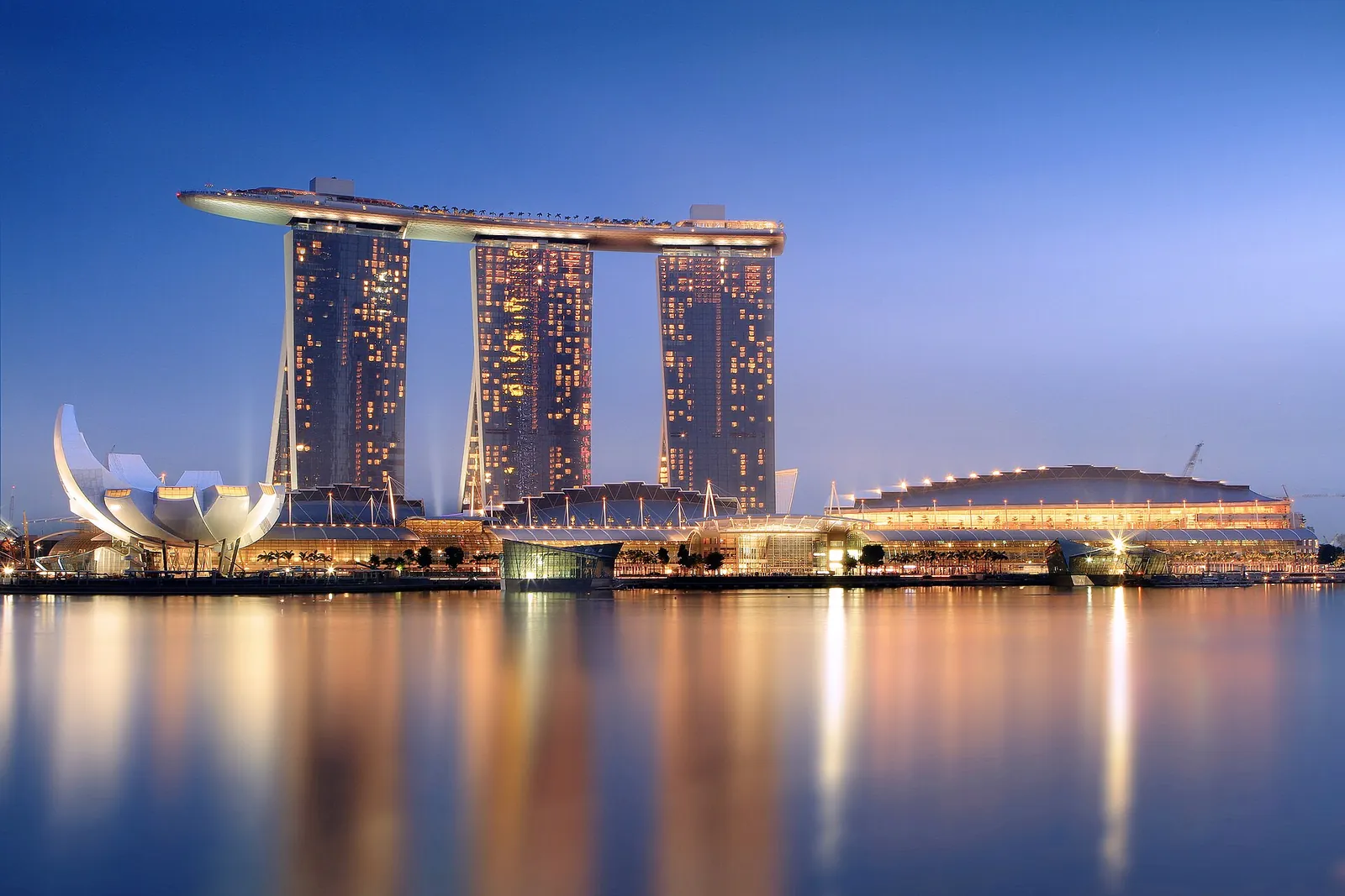 Marina Bay Sands glowing over the bay at dusk