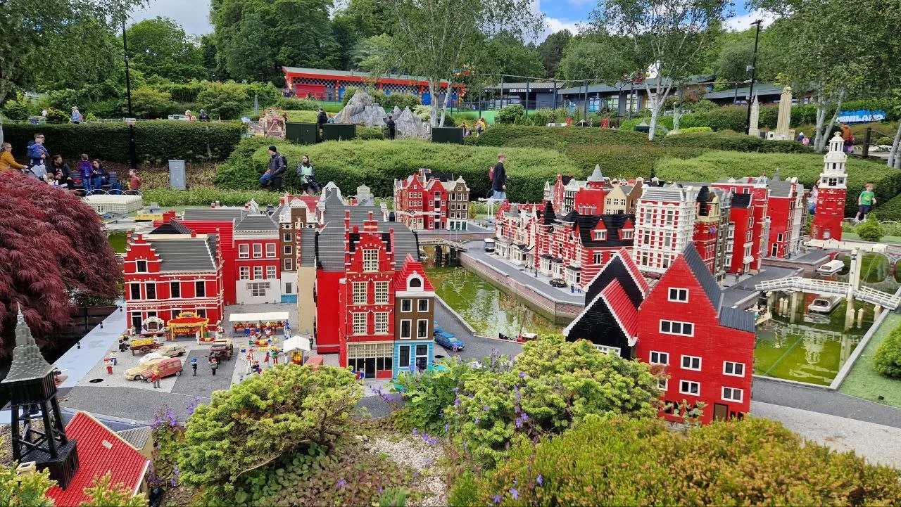 Lego models of colourful canal houses in Legoland Windsor's Miniland, surrounded by gardens