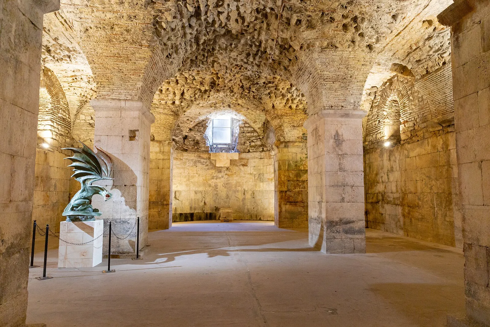 Warmly lit vaulted halls of the palace cellars