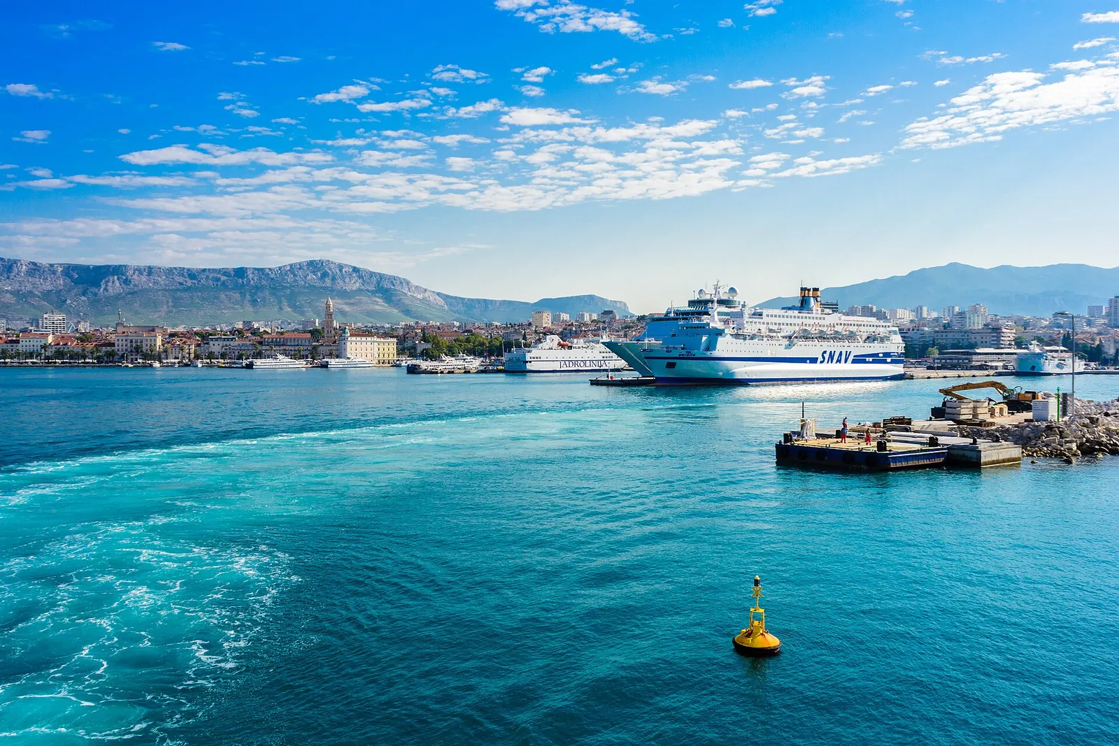 Ferries in Split harbour with mountains behind