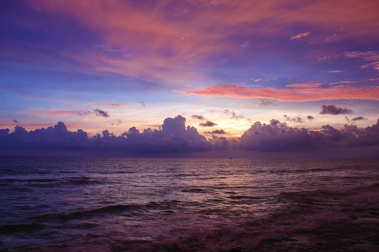A purple and pink sunset over the sea at Galle Face Green