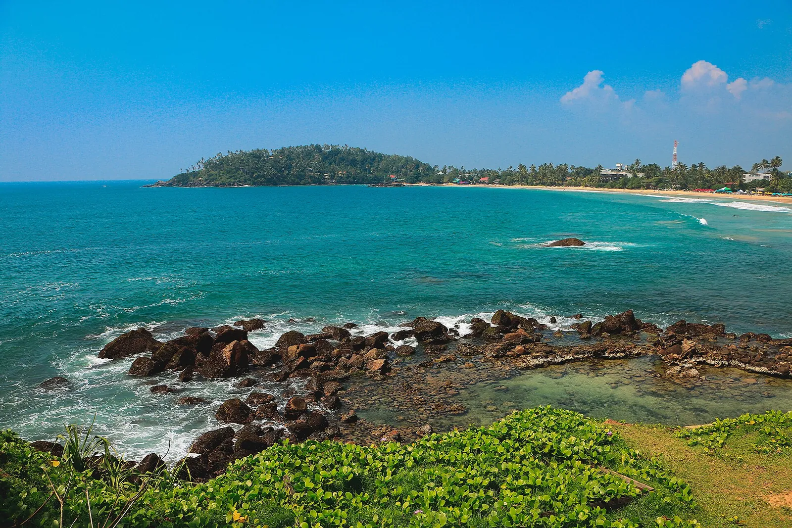 Turquoise water and rocky shore at Mirissa