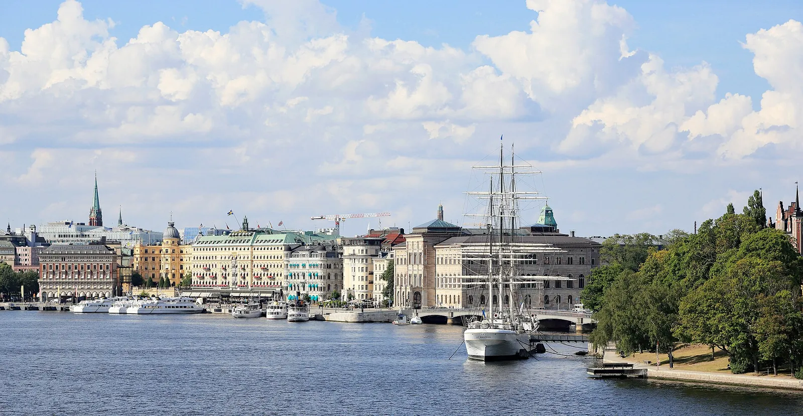 Sunny Stockholm waterfront with a tall ship moored