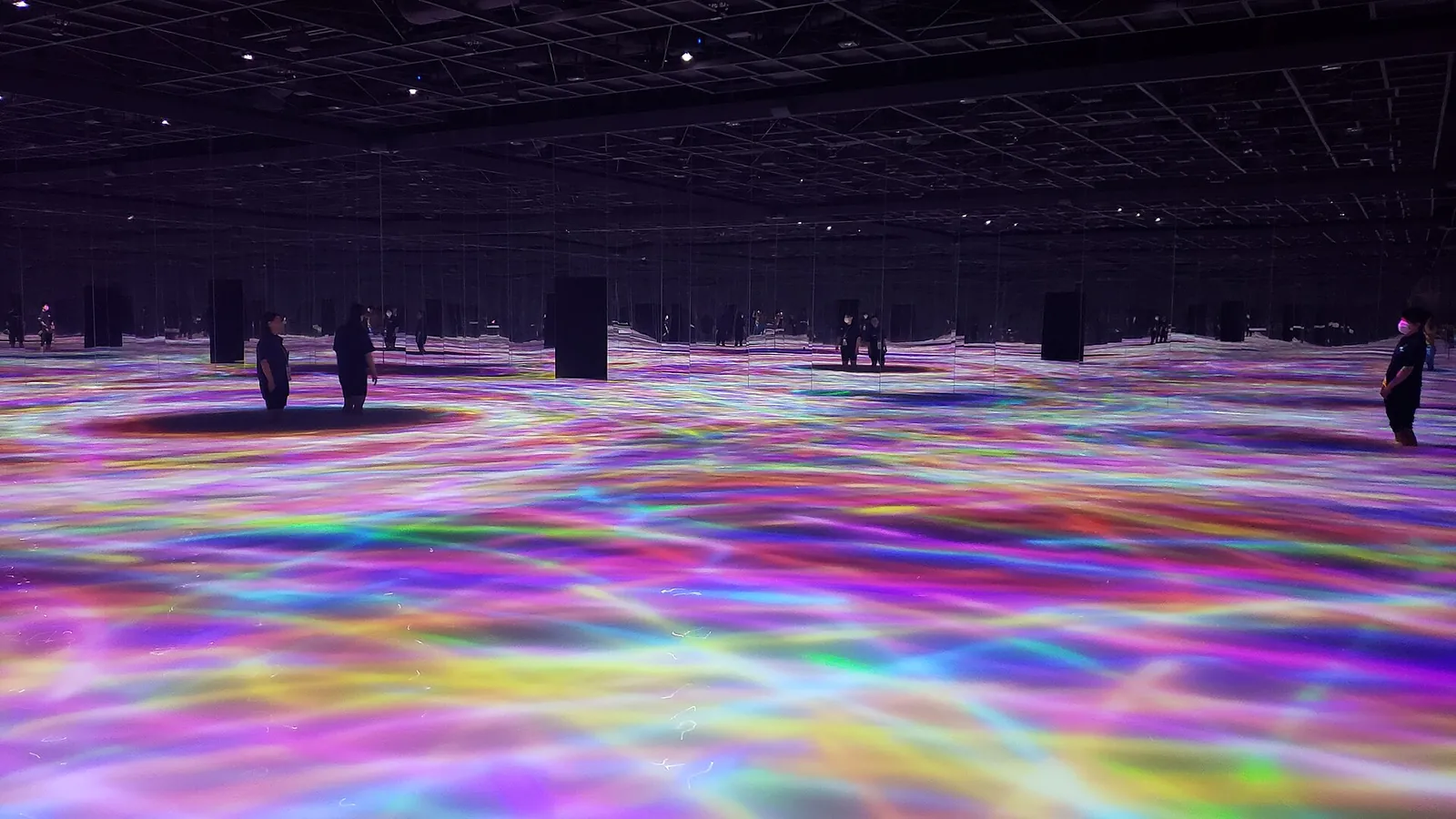 Rainbow light rippling across the floor at teamLab Planets