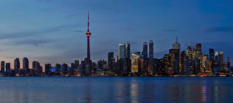 Toronto skyline and CN Tower glowing at sunset