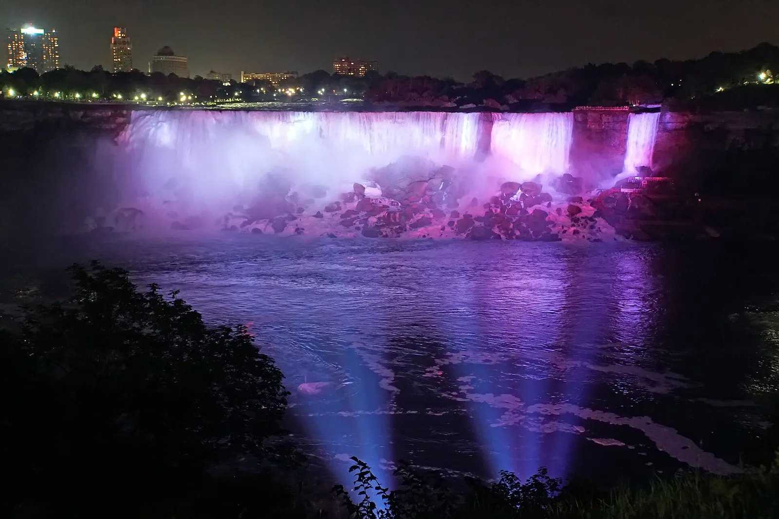 Niagara Falls lit up in purple and pink at night