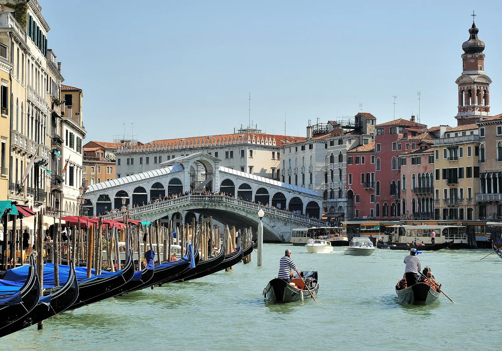Gondolas gliding towards the Rialto Bridge