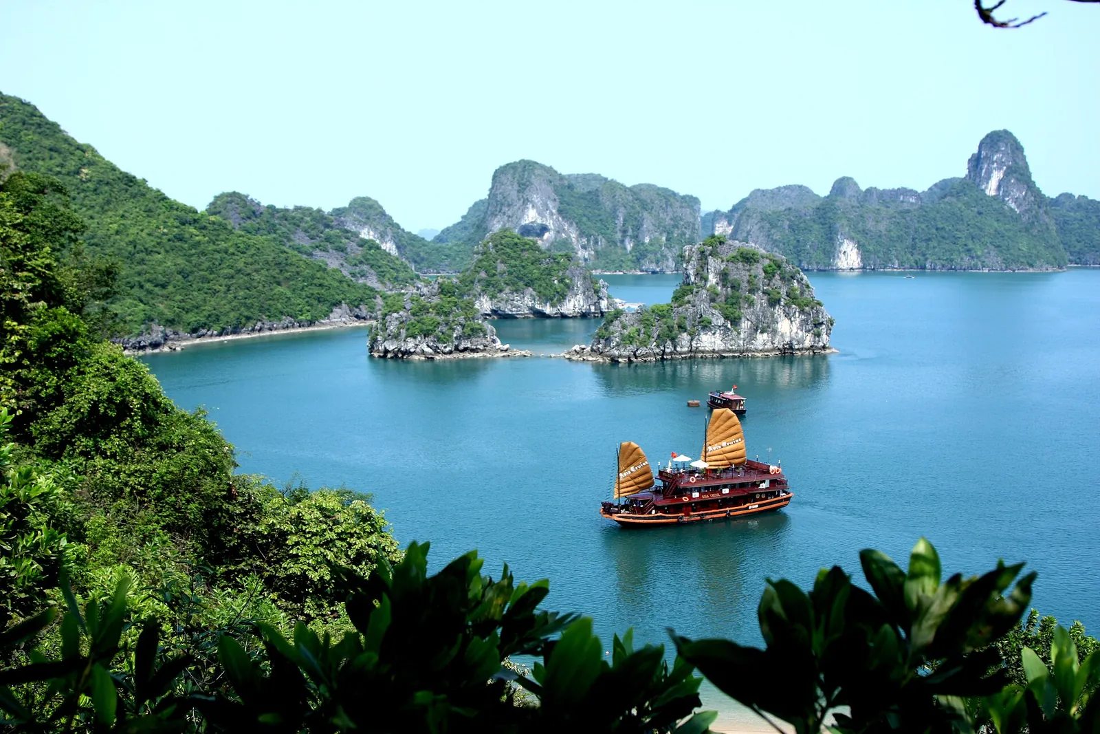 A junk sailing among Ha Long Bay's limestone islands