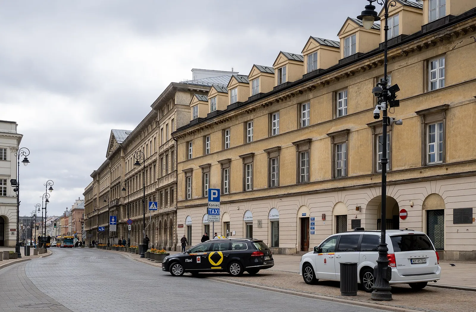 Sunlit pastel buildings along Krakowskie Przedmieście
