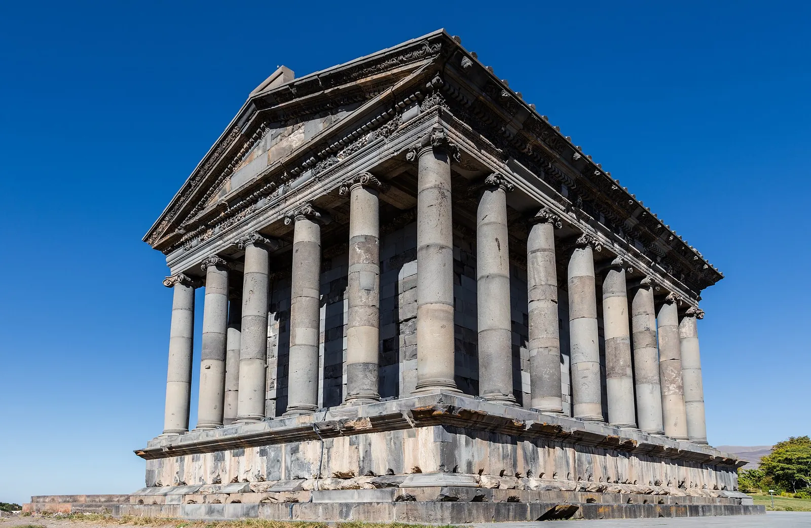 Garni Temple's columns against a deep blue sky