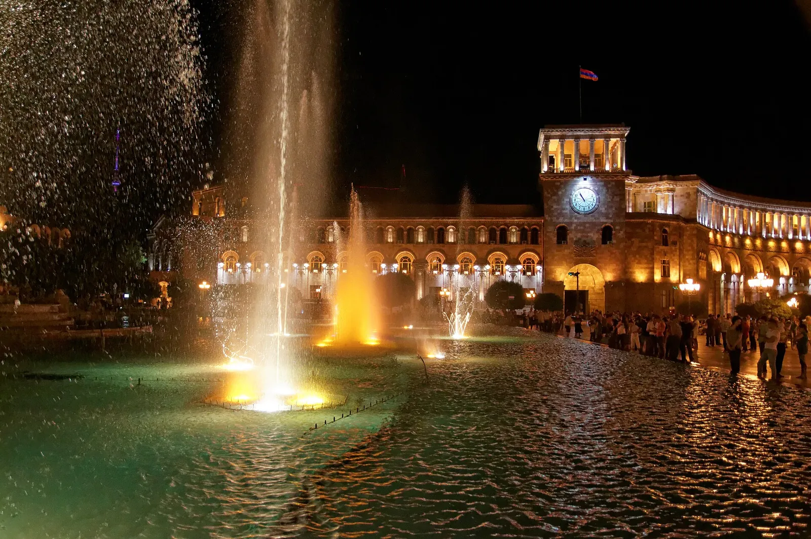 Republic Square's fountains glowing at night