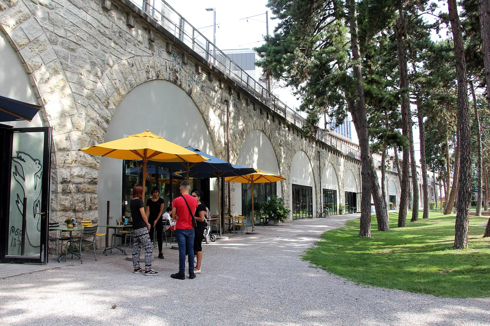 Sunny café terraces under the Im Viadukt arches