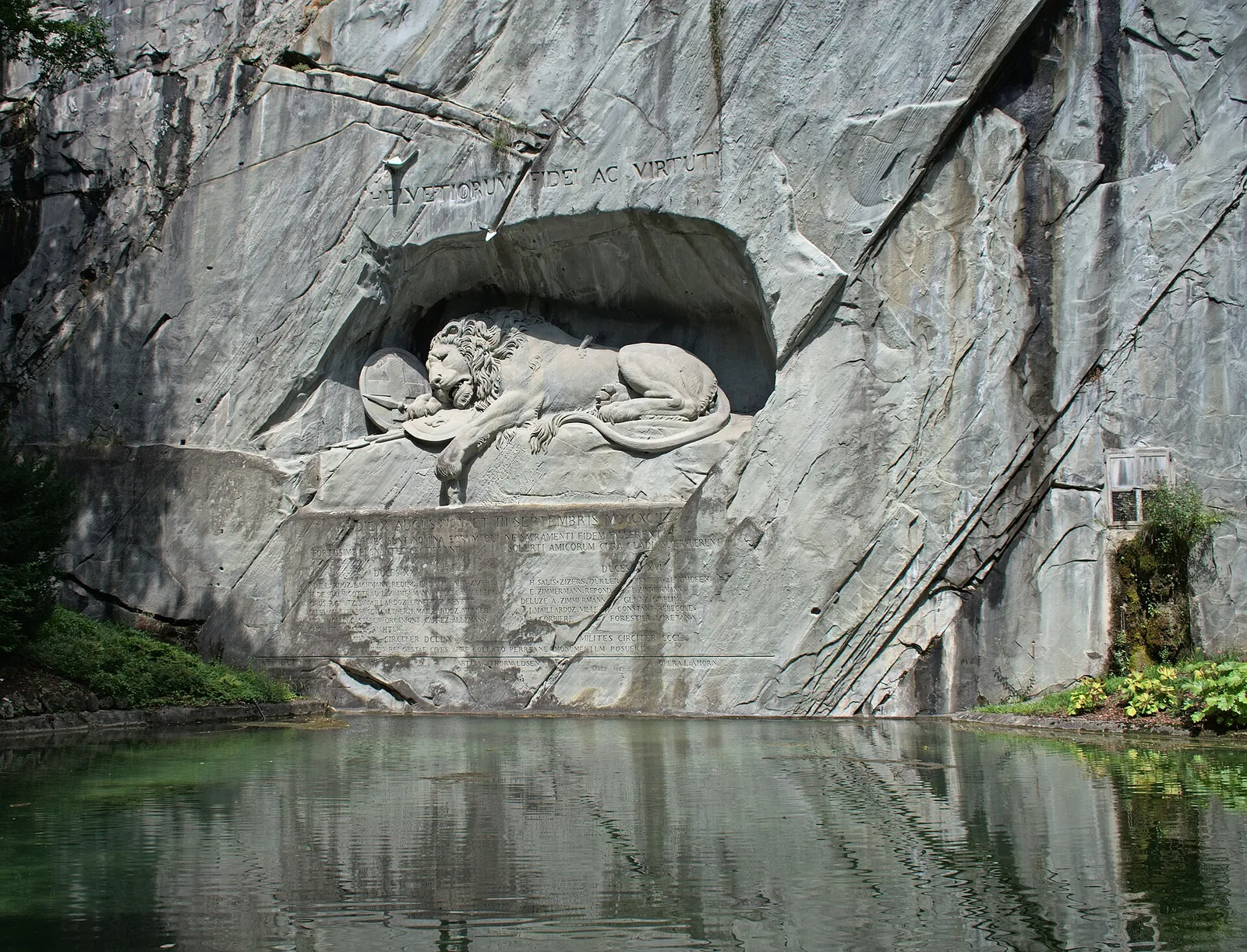 The Lion Monument carved into the rock above its pond